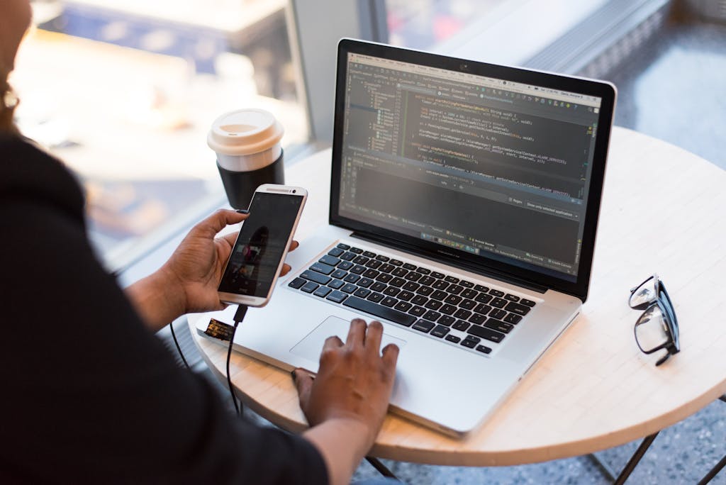 Code on a laptop screen illustrates technical work behind website speed improvements.