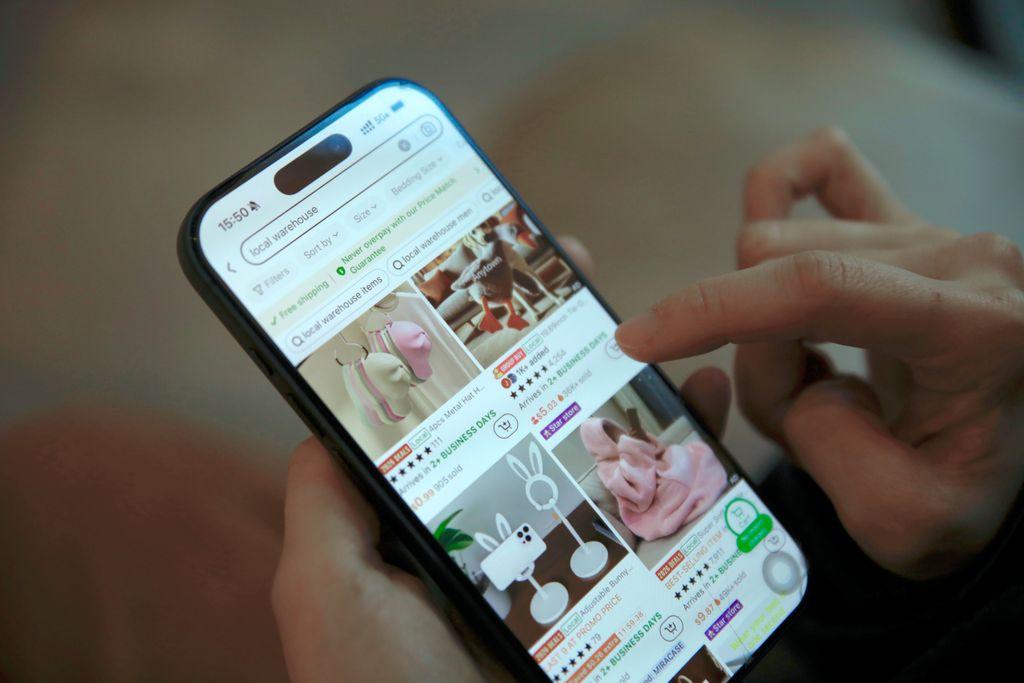 Person tapping an online shopping app on a smartphone