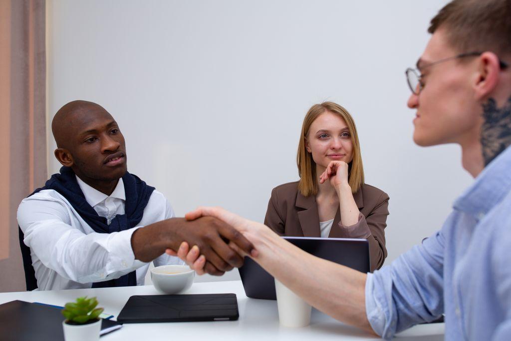 Professionals meeting and shaking hands across a table