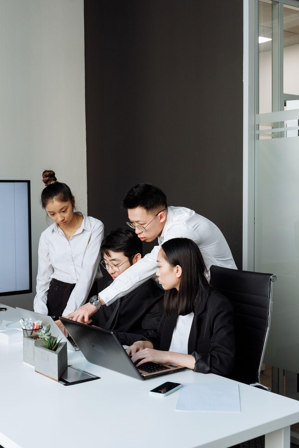 Team reviewing a laptop together during a business meeting